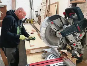  ??  ?? Crowd-sourcing: A worker at the BWRP cuts up planks of wood to sell to customers. The firm is raising funds from the public for a premises. — Reuters