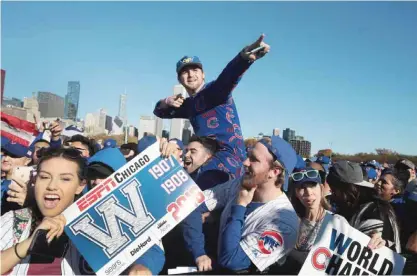  ??  ?? CHICAGO: Chicago Cubs fans attend a rally in Grant Park to celebrate the team’s World Series victory on Friday in Chicago, Illinois. Hundreds of thousand of people lined the streets in downtown Chicago as the team paraded by in double deck buses on the...