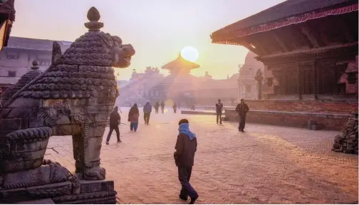  ??  ?? Morning begins as the sun rises beyond the Kedarnath Temple in Durbar Square, in Bhaktapur.| The New York Times