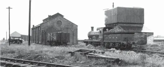  ?? W A Camwell/SLS Collection ?? A damp and gloomy Sunday, 4 July 1937 finds photograph­er and Stephenson Locomotive Society luminary Bill Camwell at Silloth, where Holmes ‘D31’ 4-4-0 No 9213 gently simmers outside the shed, beside the water tower, while ‘J36’ class 0-6-0 No 9763 slumbers inside. The 4-4-0 emerged from Cowlairs Works as NBR class ‘633’ No 213 in June 1895, and it proved to be a Carlisle Canal resident from August 1935 until withdrawn in March 1939, going to Cowlairs for disposal. The ‘J36’ was another Canal stalwart, latterly as British Railways No 65321. The line in the foreground is to the turntable, and note the ever-present heaps of ash and clinker. The siting of the wagon of loco coal outside the shed suggests that some hand coaling is now performed at this point, although the coaling dock is still extant on the south side of the shed.