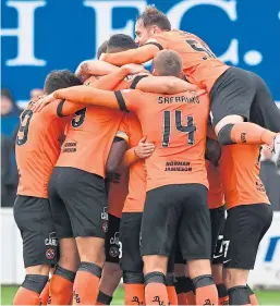  ?? Pictures: SNS. ?? Nicky Clark, top, fires home Dundee United’s winner from the penalty spot and celebrates with team-mates.