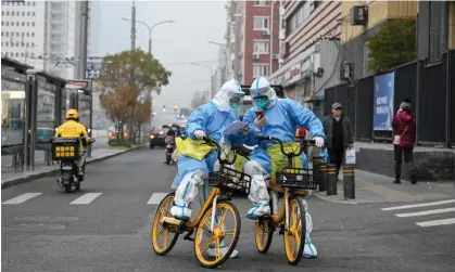  ?? ?? Health workers in PPE deliver Covid tests in Beijing last week. Photograph: Jade Gao/AFP/GettyImage­s