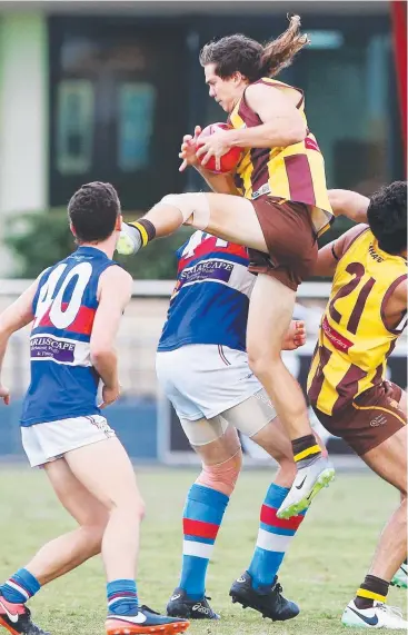  ?? Pictures: BRENDAN RADKE ?? UP THERE: Corey Flint takes a screamer for the Hawks right in front of the grandstand at Cazalys against Centrals Trinity Beach Bulldogs.