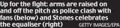  ?? GETTY IMAGES/EPA ?? Up for the fight: arms are raised on and off the pitch as police clash with fans (below) and Stones celebrates the equaliser (right)