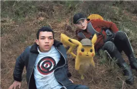  ?? WARNER BROS. ?? Tim (Justice Smith, left), Pikachu (voiced by Ryan Reynolds) and Lucy (Kathryn Newton) are on the case in “Pokemon: Detective Pikachu.”