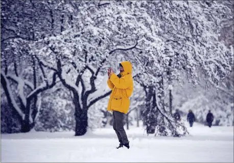  ?? JUSTIN TANG — THE CANADIAN PRESS VIA AP ?? A person takes a photo with their phone during a major snowstorm in Ottawa on Saturday, Jan. 16, 2021.