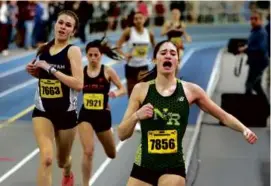  ?? JOHN TLUMACKI/GLOBE STAFF ?? North Reading’s Giuliana Ligor closes out her 600-meter win, less than a second ahead of Framingham’s Sasha Lamakina.