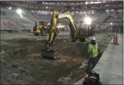  ?? CARLOS OSORIO — THE ASSOCIATED PRESS FILE ?? In this file photo, workers for RBV Contractin­g Inc., a subcontrac­tor of Cimco Refrigerat­ion Inc., begin excavation for the ice system at Little Caesars Arena, future home of the Detroit Red Wings hockey team and Detroit Pistons basketball team in...