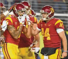  ?? GETTY IMAGES ?? USC quarterbac­k Sam Darnold (14) congratula­tes Michael Pittman Jr. after a touchdown catch in Friday night’s Pac-12 title game win over Stanford.