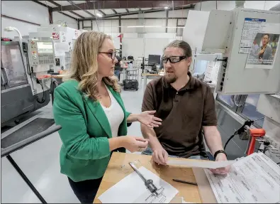 ?? Arkansas Democrat-Gazette/JOHN SYKES JR. ?? Gina Radke, chief executive officer of Galley Support Innovation­s in Sherwood (left) and engineer William Mauldin discuss the specificat­ions for producing interior hardware for commercial and private aircraft on Thursday.