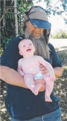  ??  ?? SMITTEN: Peter Campion meets his grandson, five-month-old Sebastian Joyce, for the first time.