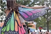  ??  ?? Jennifer Ribley of Jamestown, Pa., spreads her wings while dancing to Coin on Saturday.