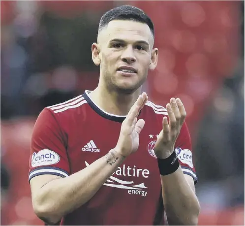  ?? ?? 0 Christian Ramirez applauds the Aberdeen fans at full-time on Saturday after his goal against Hibs earned the Dons a long-awaited win