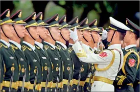  ??  ?? Chinese soldiers adjust their positionin­g before performing in an honour guard for India's Prime Minister Narendra Modi outside the Great Hall of the People in Beijing on Friday. AFP