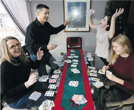  ?? PHOTOS: CODIEMCLAC­HLAN ?? Kimberley and Andreas Kuppe, from left, enjoy a game with daughters Sydney and Makenna.