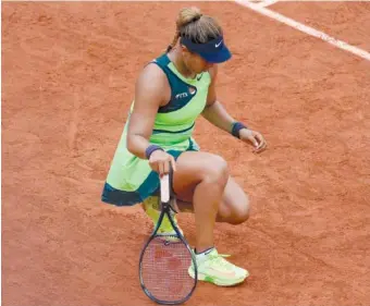  ?? AP PHOTO/CHRISTOPHE ENA ?? Japan’s Naomi Osaka stretches her left foot Monday during her first round match against Amanda Anisimova of the U.S. at the French Open in Roland Garros stadium in Paris, France.