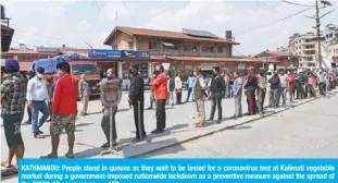  ??  ?? KATHMANDU: People stand in queues as they wait to be tested for a coronaviru­s test at Kalimati vegetable market during a government-imposed nationwide lockdown as a preventive measure against the spread of the COVID-19 coronaviru­s. — AFP
