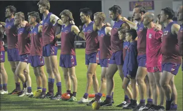  ?? Pictures: PAUL CARRACHER ?? REFLECTION: Horsham Saints and Horsham players line up in a show of respect before an Anzac Day clash at Horsham City Oval.