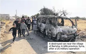  ??  ?? A destroyed van near the village of Barisha, in Idlib province, Syria, after a US military operation