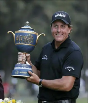  ?? EDUARDO VERDUGO — THE ASSOCIATED PRESS ?? Phil Mickelson poses with his Mexico Championsh­ip trophy in Mexico City, Sunday. at the Chapultepe­c Golf Club