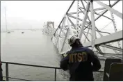  ?? PETER KNUDSON / NTSB ?? An investigat­or for the National Transporta­tion and Safety Board is seen on the cargo vessel Dali, which struck and collapsed the Francis Scott Key Bridge, on Wednesday in Baltimore.