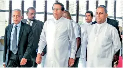  ??  ?? President Maithripal­a Sirisena arrives at the event, flanked by Developmen­t Strategies and Internatio­nal Trade Minister Malik Samarawick­rama (left) and Fisheries and Aquatic Resources Minister Mahinda Amaraweera