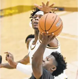  ?? KENNETH K. LAM/BALTIMORE SUN ?? UMBC’s Darnell Rogers, foreground, shoots against Coppin State’s Anthony Tarke in the first half of a game earlier this season.