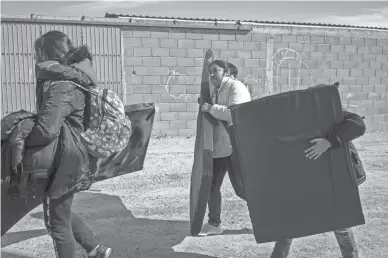  ?? NICK OZA/THE REPUBLIC FILE ?? Women from Guatemala and Guerrero, Mexico, and their children receive mattresses donated by local charities in Nogales, Sonora, Mexico, in early January.