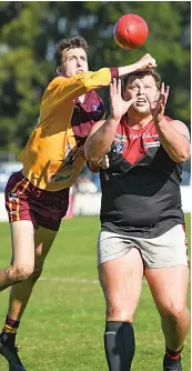  ?? Photograph­s by CRAIG JOHNSON. ?? Drouin recruit Alex McMillan punches the ball away from Warragul’s Sam Whibley.