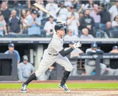  ?? USA TODAY SPORTS ?? The Yankees’ Aaron Judge hits the game-winning RBI single against Tampa Bay in New York on Sunday.