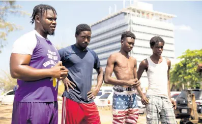  ?? PHOTOS BY GLADSTONE TAYLOR/MULTIMEDIA PHOTO EDITOR ?? From left: Kareen Bennett, Akiva Murray, Thierry Tomlinson and Kadeef Clarke are among scores of young men and women from Parade Gardens who fill their spare time with the activity of diving at their regular spot on the Kingston waterfront.