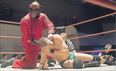  ?? SUBMITTED ?? Vorhees, left, strangles an opponent in a match from 2016. Vorhees is part of two Red Rock Wrestling shows coming to Montague and Summerside next month.