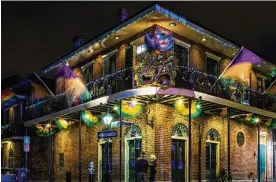  ?? DREAMSTIME/TNS ?? Pubs and Bars display colorful lights and decoration­s in the French Quarter of New Orleans.