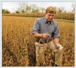  ?? JIM WITMER / STAFF FILE ?? ABOVE: Tim Hewitt looks at his soybean crop on his farm on Farmersvil­le West Carrollton Road.