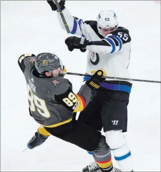  ??  ?? Las Vegas Review-journal Winnipeg center Mark Scheifele, right, delivers a crunching hit to Alex Tuch in a November clash at T-mobile Arena — a 5-2 Golden Knights’ victory.