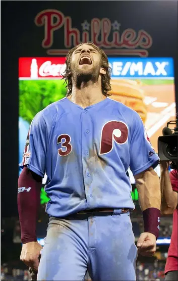  ?? CHRIS SZAGOLA — THE ASSOCIATED PRESS ?? The Phillies’ Bryce Harper celebrates after his walk-off grand slam in the ninth to beat the Cubs Thursday night.