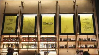  ?? ANTONIO CALANNI/AP ?? A Starbucks sign advertises the company’s Oleato coffee — with olive oil — at a store in Milan, Italy.