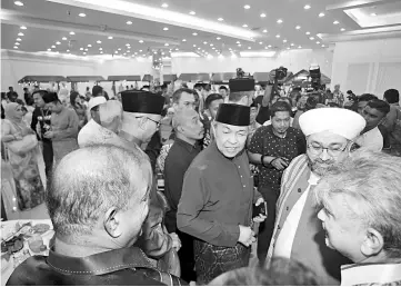  ??  ?? Datuk Seri Dr Ahmad Zahid Hamidi (center) at the Aidilfitri Open House. - Bernama photo