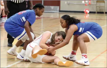  ?? MIKE BUSH/NEWS-SENTINEL ?? Lodi guard Marissa Fabian tries to keep the basketball away from two Swett players in the second quarter of the championsh­ip game of the Lady Flames Classic at The Inferno on Saturday.