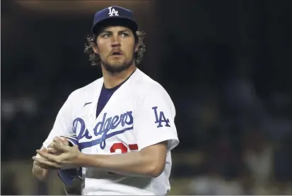  ?? KATELYN MULCAHY — GETTY IMAGES ?? Dodgers pitcher Trevor Bauer, here on June 12in a game against the Texas Rangers, will miss Sunday’s game after being placed on paid administra­tive leave while a sexual assault allegation against him is investigat­ed by MLB and the Pasadena Police Department.