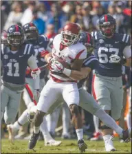  ?? NWA Democrat-Gazette/Ben Goff ?? TURNING POINT: Arkansas free safety Josh Liddell tries to break the tackle of Ole Miss running back Jordan Wilkins as he returns an intercepti­on in the second quarter Saturday. Arkansas rallied from a 31-7 deficit to beat the Rebels 38-37 on Connor...