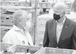  ?? PATRICK SEMANSKY/AP ?? President Joe Biden speaks with a Houston Food Bank volunteer Friday. Texas was hit particular­ly hard this month by a storm that battered multiple states.