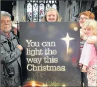  ??  ?? From left Trevor Johnson, Anna Whittaker, Ruth Henderson and youngster Faye with a giant Christian Aid Christmas Card