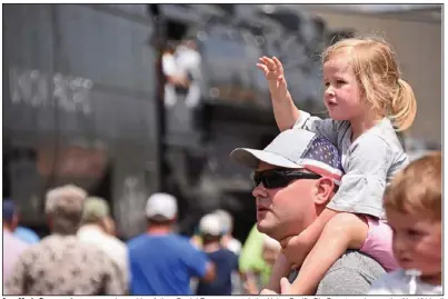  ?? (Arkansas Democrat-Gazette/Staci Vandagriff) ?? AnneMarie Ramage, 3, waves as she and her father, Daniel Ramage, watch the Union Pacific Big Boy steam locomotive No. 4014 roll to a stop Thursday at the Union Pacific facility in North Little Rock. More photos at arkansason­line.com/827steam/.