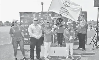  ?? — Gambar Muhammad Rais Sanusi ?? CHAMPION 2018: Fatimah nyuaka tropi champion ngagai ketuai kontinjen Kuching di Unimas, Kota Samarahan kemari.