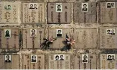  ?? AP ?? Space constraint­s Storage boxes with niches for cremated remains are seen at a public columbariu­m in Hong Kong. To store the ashes, the government builds large structures known as columbariu­ms that have tens of thousands of niches for urns as well as...