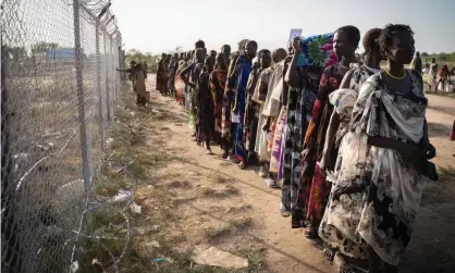  ?? Photograph: Simon Wohlfahrt/AFP/Getty Images ?? Women from Murle ethnic group wait in a line for a food distributi­on by the UN World Food Programme in Gumuruk, South Sudan.