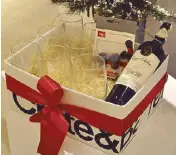  ??  ?? Crate&Barrel Christmas hamper, P2,000, includes eight stemless red wine glasses, vacuum wine stoppers and Casa Silva merlot wine.