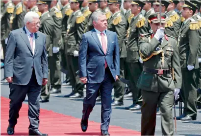  ?? AFP ?? Palestinia­n President Mahmoud Abbas and Jordan’s King Abdullah observe the honour guard in Ramallah on Monday. —