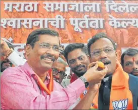  ?? BHUSHAN KOYANDE/HT PHOTO ?? Education minister Vinod Tawde celebrates the passing of the Maratha quota bill, with party workers at the BJP’S office in Nariman Point on Thursday.